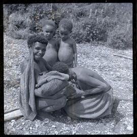 Mother Showing Baby to Women and Children