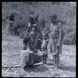 Mother Showing Baby to Women and Children