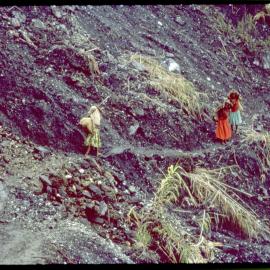 Three Women with Net Bags on Mountain Path