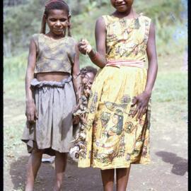 Two Girls, One with a String of Frogs