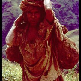Woman Carrying Bag of Sweet Potatoes