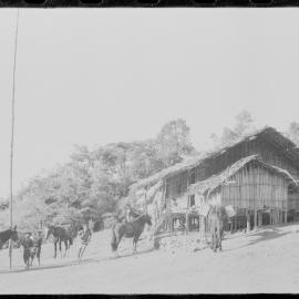 Loading Horses Outside a Building