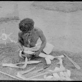 Man Stripping Tree Bark