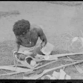Man Stripping Tree Bark