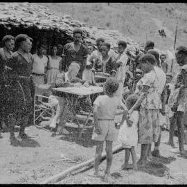 Group Gathered Around Man at Desk