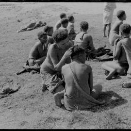 Women Sitting, Some with Net Bags