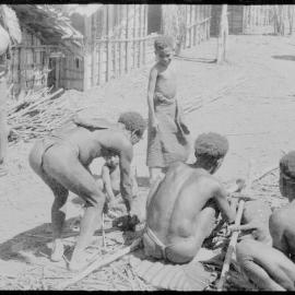 Group Preparing Pigs for a Ceremony