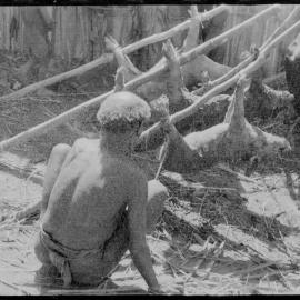 Man Preparing Pigs for a Ceremony