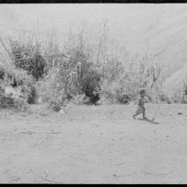 Child Walking on Mountainside Path