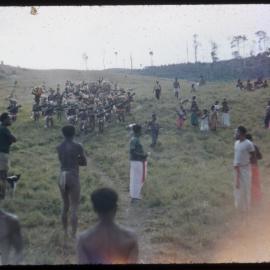 Group with Drums Gathered on Mountainside as Crowd Watches