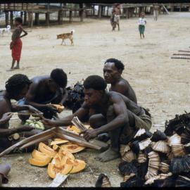 Men and Children Preparing Pumpkins