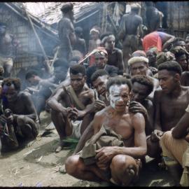Men Sitting Outside a Building