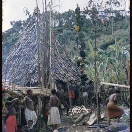 People Gathered Around Food Poles
