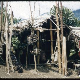 Building with Poles of Plants and Fruits Outside