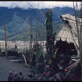 Men Climbing Food Pole