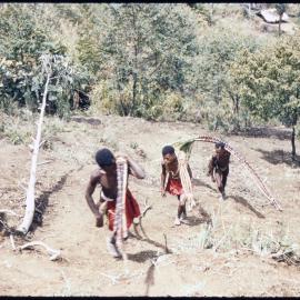 Men Carrying Branches Uphill