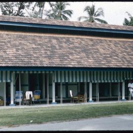 Man Standing Outside a House