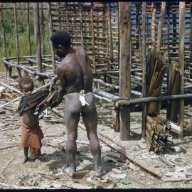 Man and Child Constructing a Building