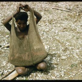 Woman Sitting with Net Bag