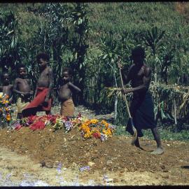 Group Standing Next to Grave