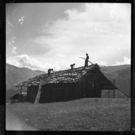 Three Figures Working on a Roof