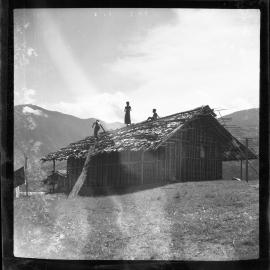 Three Figures Working on a Roof