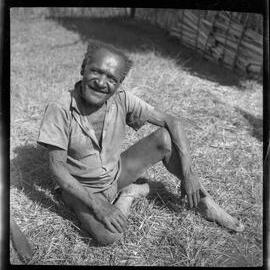 Man Sitting Outside a Building