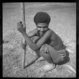 Girl Sitting with a Stick