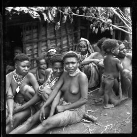 Women and Children Sitting Outside a Building