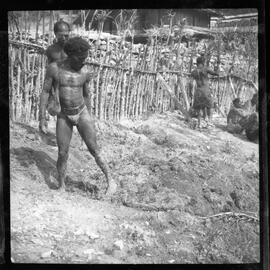 Men Gathered Along a Fence
