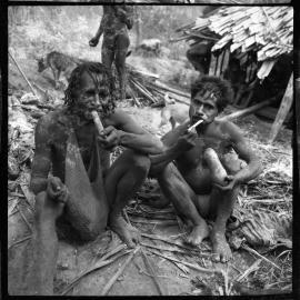 Two Men Sitting Outside a Building