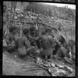 Group of Men Gathered Around a Butchered Pig