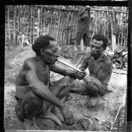 Two Men Sitting Outside a Building