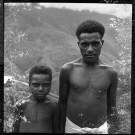 Man and Child Standing on Mountainside