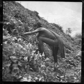 Woman with Net Bag Collecting Plants