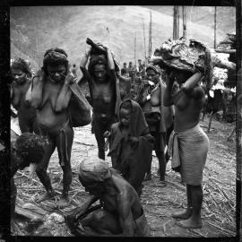 Group Carrying Pork and Net Bags