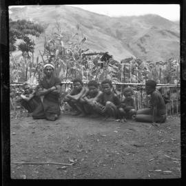 Group Sitting Along a Fence
