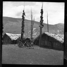 Group Sitting at Base of Food Poles