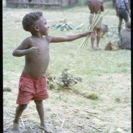 Child Holding Sticks