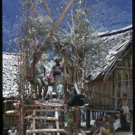 Couple Sitting on Elevated Platform in Village