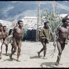 Men Walking Through a Village
