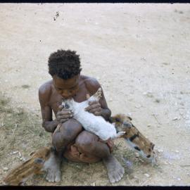 Person Sitting with Piglets