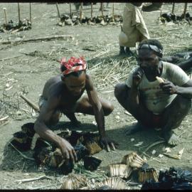 Men Eating Pandanus Nuts
