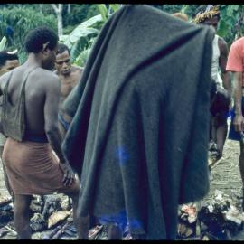 Men Gathered Around Food Piles