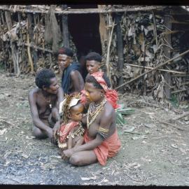 Women and Child Sitting Outside a Building