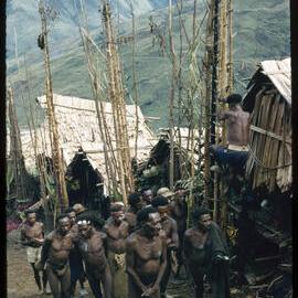 Group of Men Walking Through a Village