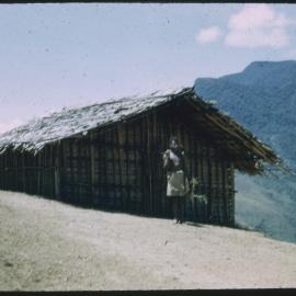 Man Standing Outside Mountainside Building