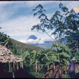 Men and Children Gathered with Mountain in Background