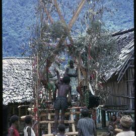 Couple Sitting on Elevated Platform in Village