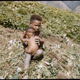 Child Holding a Baby